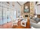 Bright living room with stone fireplace, hardwood floors, and sheer window curtains at 100 Longspur Ct, Daytona Beach, FL 32119