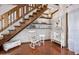 Inviting living room showcases rustic stairs, wood floors, and decorative white furniture and shelving accents at 100 Longspur Ct, Daytona Beach, FL 32119