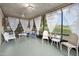 Relaxing screened-in porch with ample seating and views of the surrounding landscape at 100 Longspur Ct, Daytona Beach, FL 32119