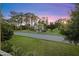 Scenic street view showcasing lush landscaping, mature trees, and a serene residential environment at 100 Longspur Ct, Daytona Beach, FL 32119