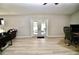 Open living room showcasing French doors leading to the backyard at 1545 Huntington St, Deltona, FL 32725