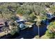 Aerial view showcasing a waterfront home with a private dock and storage shed at 1069 Indigo Rd, Ormond Beach, FL 32174