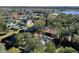 Aerial view of a house on the water with a dock and surrounding homes at 1069 Indigo Rd, Ormond Beach, FL 32174