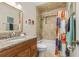 Bathroom with tub shower, granite vanity, and colorful shower curtain at 1069 Indigo Rd, Ormond Beach, FL 32174