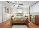 Cozy bedroom with wood bed frame and ceiling fan at 1069 Indigo Rd, Ormond Beach, FL 32174