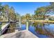 Peaceful waterfront view with a wooden dock at 1069 Indigo Rd, Ormond Beach, FL 32174