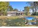 House exterior showcasing a ranch-style home with a covered porch and a yard at 1069 Indigo Rd, Ormond Beach, FL 32174