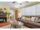 Cozy living room featuring a leather sofa, coffee table, and hardwood floors at 1069 Indigo Rd, Ormond Beach, FL 32174