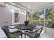 Screened porch with outdoor table and canal view at 1069 Indigo Rd, Ormond Beach, FL 32174