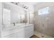 Modern bathroom with double vanity, quartz countertop and a large walk-in shower at 1281 Champions Dr, Daytona Beach, FL 32124