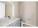 Modern powder room with gray vanity and toilet at 1281 Champions Dr, Daytona Beach, FL 32124