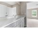 Modern bathroom with gray vanity, quartz countertop, and an updated sink at 1281 Champions Dr, Daytona Beach, FL 32124