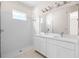 Bathroom with double vanity, white subway tile shower and quartz countertop at 1281 Champions Dr, Daytona Beach, FL 32124