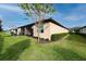 Home's backyard features a screened patio and grassy lawn at 3242 Bailey Ann Dr, Ormond Beach, FL 32174