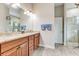 Elegant bathroom with double sinks, granite counters, and a walk-in shower at 3242 Bailey Ann Dr, Ormond Beach, FL 32174