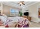 Main bedroom with king bed and a large window at 3242 Bailey Ann Dr, Ormond Beach, FL 32174
