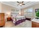 Elegant main bedroom with a king-size bed and tray ceiling at 3242 Bailey Ann Dr, Ormond Beach, FL 32174