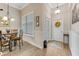 Bright entryway with wood-look floors, white door, and window with shutters at 3242 Bailey Ann Dr, Ormond Beach, FL 32174