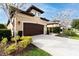 Two-story house with brown garage door, driveway, and landscaping at 3242 Bailey Ann Dr, Ormond Beach, FL 32174