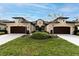 Three attached houses with brown garage doors and green lawns at 3242 Bailey Ann Dr, Ormond Beach, FL 32174