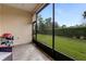 Screened lanai with tile flooring, wicker furniture, and a grill at 3242 Bailey Ann Dr, Ormond Beach, FL 32174