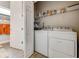 Convenient laundry room with washer, dryer, and shelving at 3242 Bailey Ann Dr, Ormond Beach, FL 32174