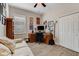 Home office with a desk, chair, sofa, and built-in shelving at 3242 Bailey Ann Dr, Ormond Beach, FL 32174