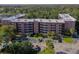 Aerial view of Tomoka Oakwood North condos, showing building and parking lot at 640 N Nova Rd # 212, Ormond Beach, FL 32174
