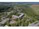 An apartment building nestled in a wooded area, with a parking lot and surrounding landscape at 640 N Nova Rd # 212, Ormond Beach, FL 32174