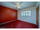 Bedroom with red carpet, ceiling fan and window with shutters at 640 N Nova Rd # 212, Ormond Beach, FL 32174