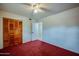 Bedroom with red carpet, ceiling fan and double doors to closet at 640 N Nova Rd # 212, Ormond Beach, FL 32174