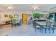 Bright community room with tables, chairs, and ceiling fans at 640 N Nova Rd # 212, Ormond Beach, FL 32174