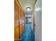 Hallway with blue carpet and wood closet doors at 640 N Nova Rd # 212, Ormond Beach, FL 32174