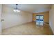 Living room with tiled floors and access to balcony at 640 N Nova Rd # 212, Ormond Beach, FL 32174