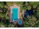 Aerial view of a refreshing pool area with lounge chairs and lush landscaping at 640 N Nova Rd # 212, Ormond Beach, FL 32174