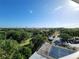 Scenic aerial view showcasing a tennis court, lush green landscape, and a glimpse of the city skyline at 935 N Halifax Ave # 602, Daytona Beach, FL 32118