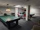 Billiard room with pool tables and seating, offering a fun and relaxing space for residents and guests at 935 N Halifax Ave # 602, Daytona Beach, FL 32118
