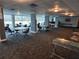Spacious clubhouse with tables, chairs, and windows at 935 N Halifax Ave # 602, Daytona Beach, FL 32118