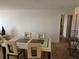Elegant dining area with a contemporary table set, stylish chairs, and wood laminate flooring at 935 N Halifax Ave # 602, Daytona Beach, FL 32118