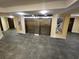 Common area with elevators, decorative art and new tile floors at 935 N Halifax Ave # 602, Daytona Beach, FL 32118