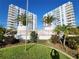 Condominium buildings with multiple balconies surrounded by tropical landscaping and green grass at 935 N Halifax Ave # 602, Daytona Beach, FL 32118