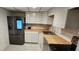 Modern kitchen featuring stainless steel appliances, butcher block countertops, and white cabinets at 935 N Halifax Ave # 602, Daytona Beach, FL 32118