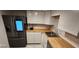 Well-lit kitchen showcasing updated appliances, wood countertops and sleek cabinetry at 935 N Halifax Ave # 602, Daytona Beach, FL 32118