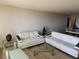 Bright living room furnished with modern sofas, glass coffee tables, and sleek decor at 935 N Halifax Ave # 602, Daytona Beach, FL 32118