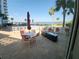Outdoor patio with table, chairs and fire pit, offering a scenic view of the pool and waterfront at 935 N Halifax Ave # 602, Daytona Beach, FL 32118