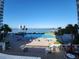 Waterfront resort style pool with lounge chairs, tables and palms with a view of the pier at 935 N Halifax Ave # 602, Daytona Beach, FL 32118