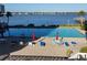 Waterfront resort-style pool surrounded by palm trees and chairs offering a relaxing outdoor oasis at 935 N Halifax Ave # 602, Daytona Beach, FL 32118