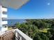 Expansive water view from a balcony overlooking lush green trees and a distant cityscape at 935 N Halifax Ave # 602, Daytona Beach, FL 32118