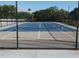Full view of community tennis court with new surfacing and fencing for recreational play at 935 N Halifax Ave # 602, Daytona Beach, FL 32118