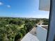 Expansive view from the balcony showcasing the lush green neighborhood and distant cityscape at 935 N Halifax Ave # 602, Daytona Beach, FL 32118
